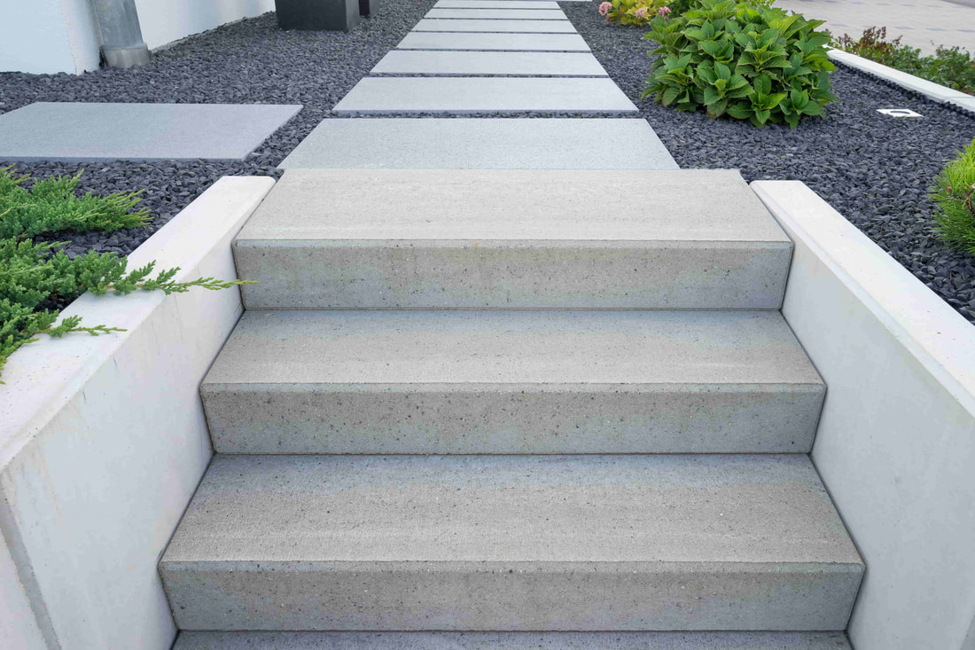 Modern concrete steps installed in a luxury homes backyard.